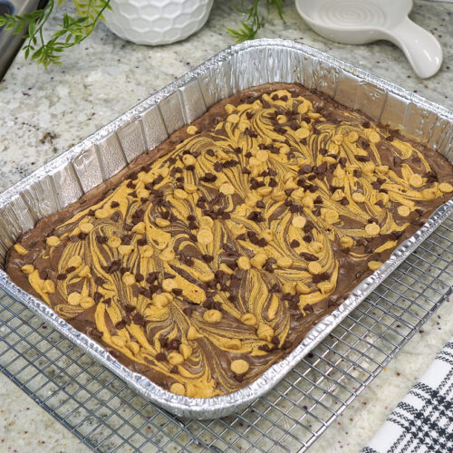 Top view of peanut butter swirl brownies in a foil pan.