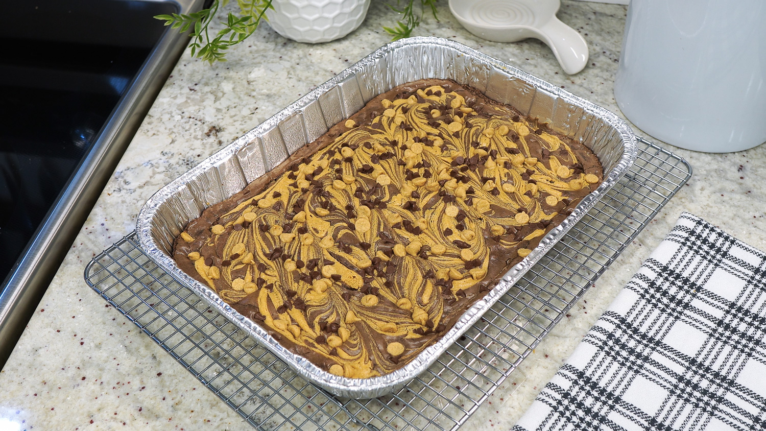 Top view of peanut butter swirl brownies in a foil pan.