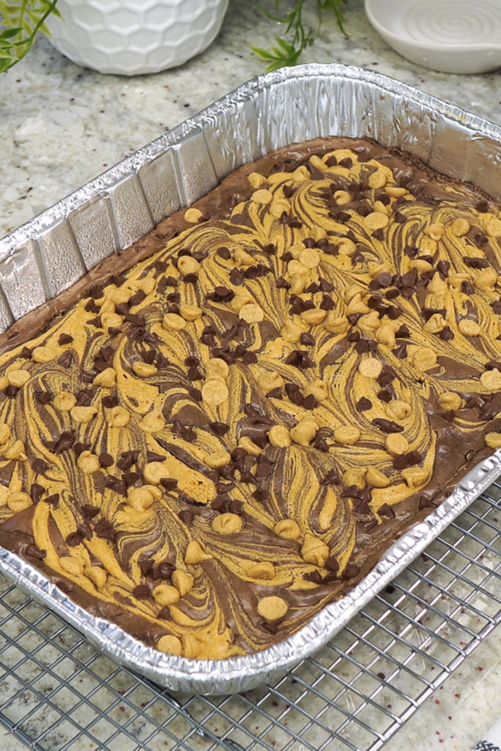 Top view of peanut butter swirl brownies in a foil pan.